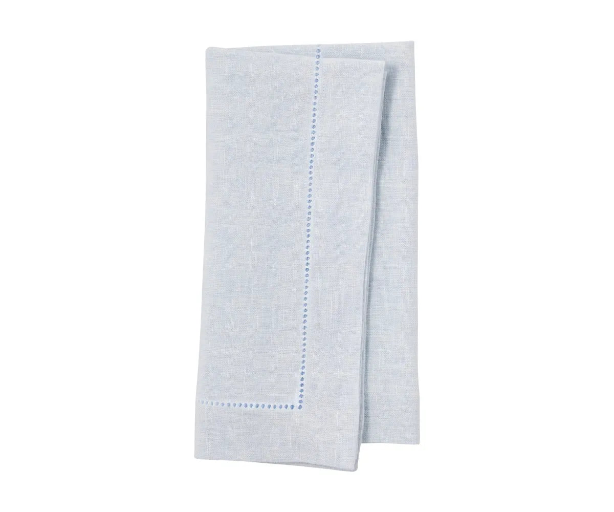 Linen napkins in soft beige folded and layered for event table setup.