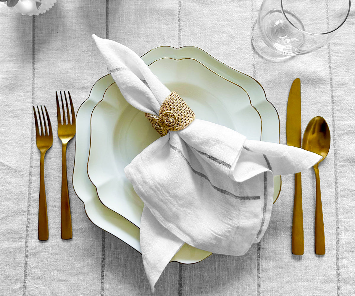 Enhance your table settings with a variety of dinner napkins, available in cloth and folding styles, in both white and black colors.Rose Gold Napkins Artfully Placed on a Banquet TableIntricate Black and Gold Napkins as Table Decorations