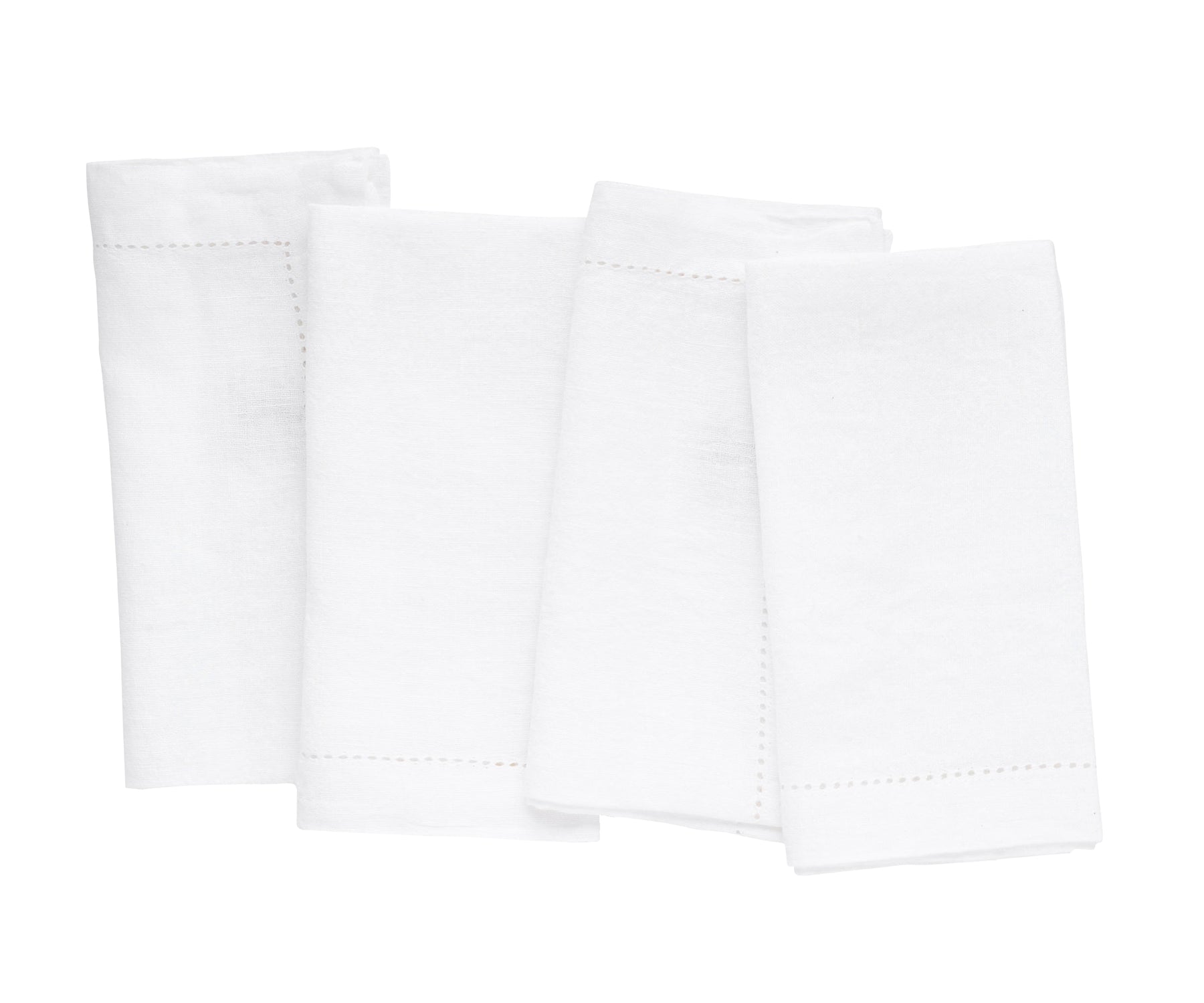 Collection of white linen napkins arranged on a pristine white backdrop