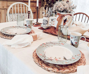 White linen napkins arranged on a dining table with dinnerware