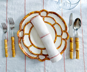 Create an elegant table setting with dinner napkins expertly folded using rings and stylishly displayed in a sophisticated napkin holder, adding a refined touch to your dining experience.