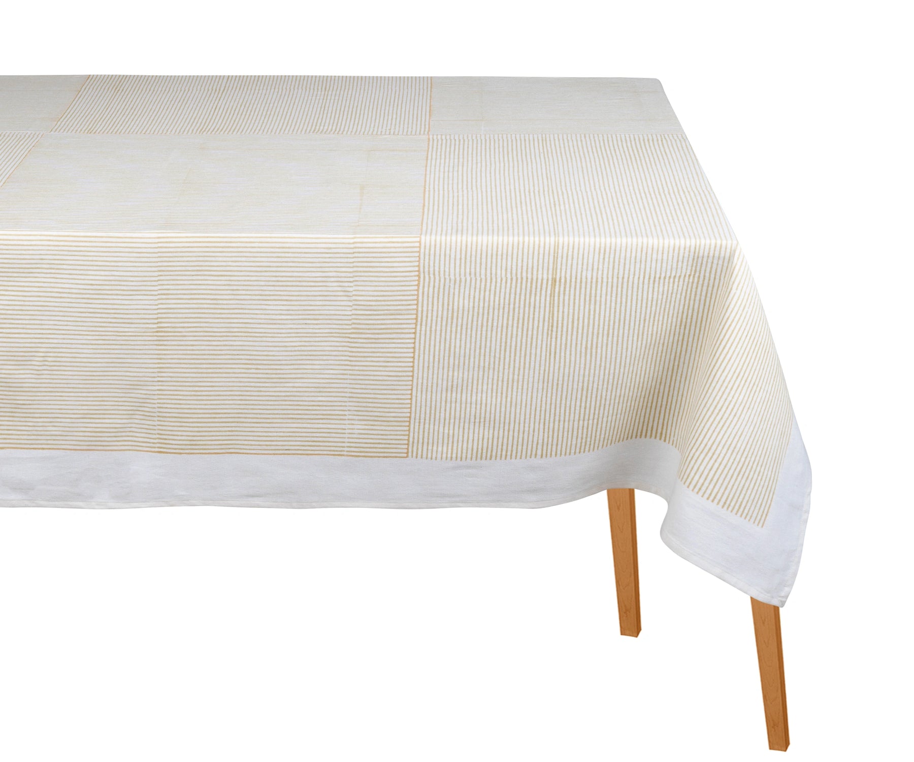 Beige cotton tablecloth draped over a farmhouse dining table with natural lighting