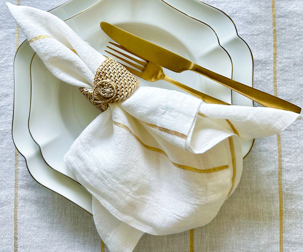 For elegant table settings, dinner napkins are offered in both cloth and folding options, with white and black varieties to choose from.Close-up Image of a Single Gold Napkin Folded in a Unique Design