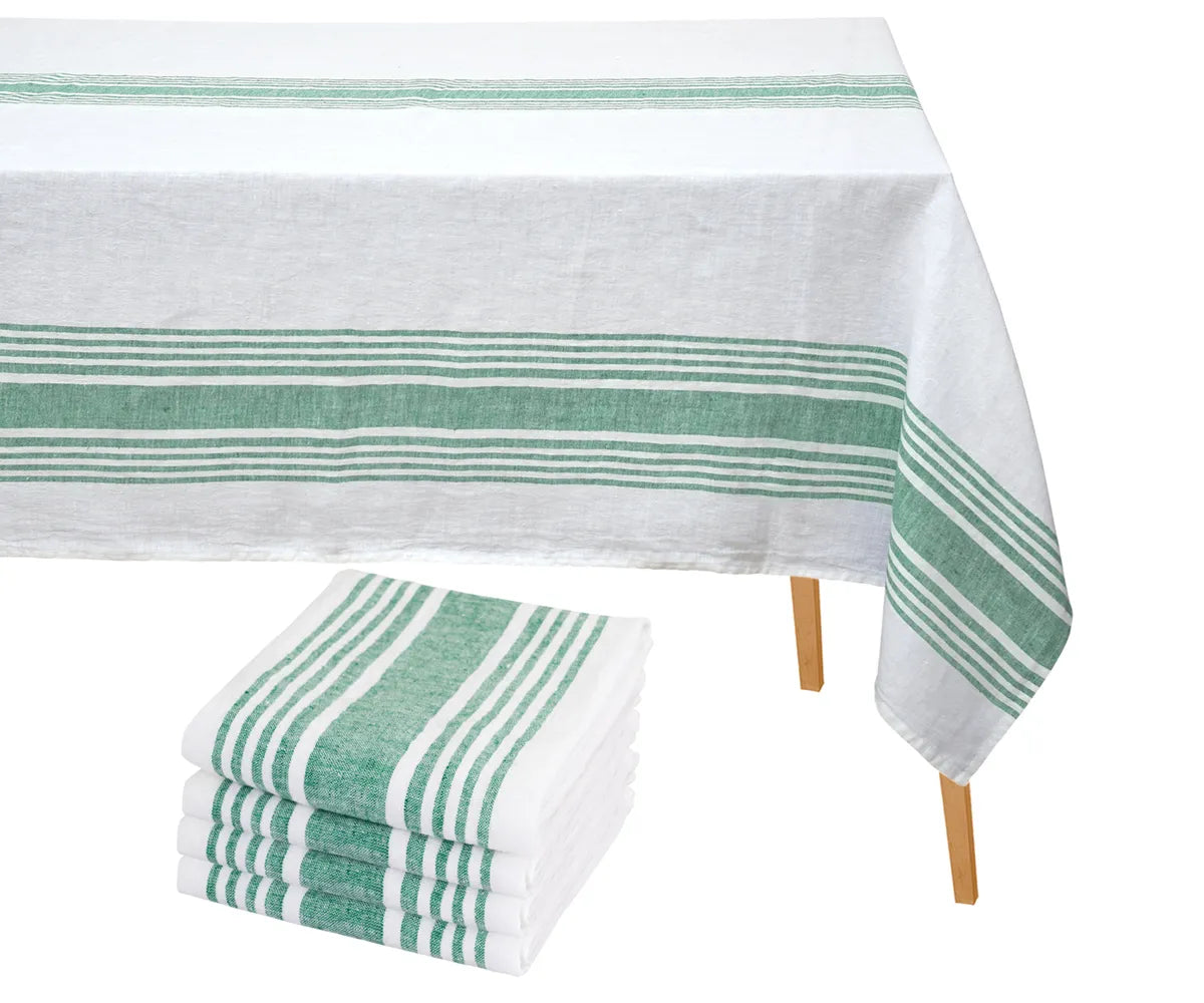 Farmhouse-style striped cotton tablecloth placed on a wooden dining table with folded napkins