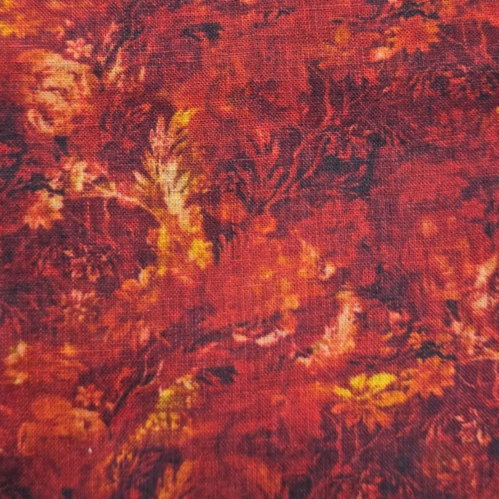 Dark red linen fabric featuring a rich floral pattern with deep burgundy tones and warm orange and golden accents against a textured woven surface.