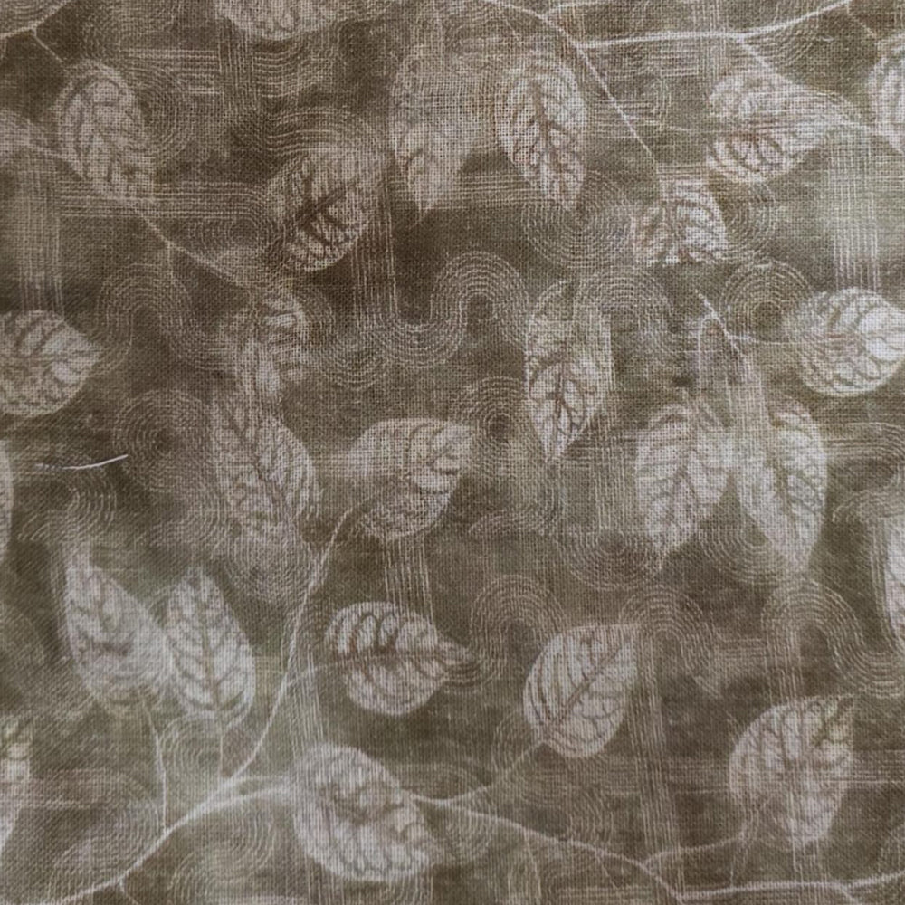 Textured round table linen with decorative pattern covering a wooden pedestal table in a minimal interior setting.