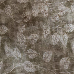 Textured round table linen with decorative pattern covering a wooden pedestal table in a minimal interior setting.