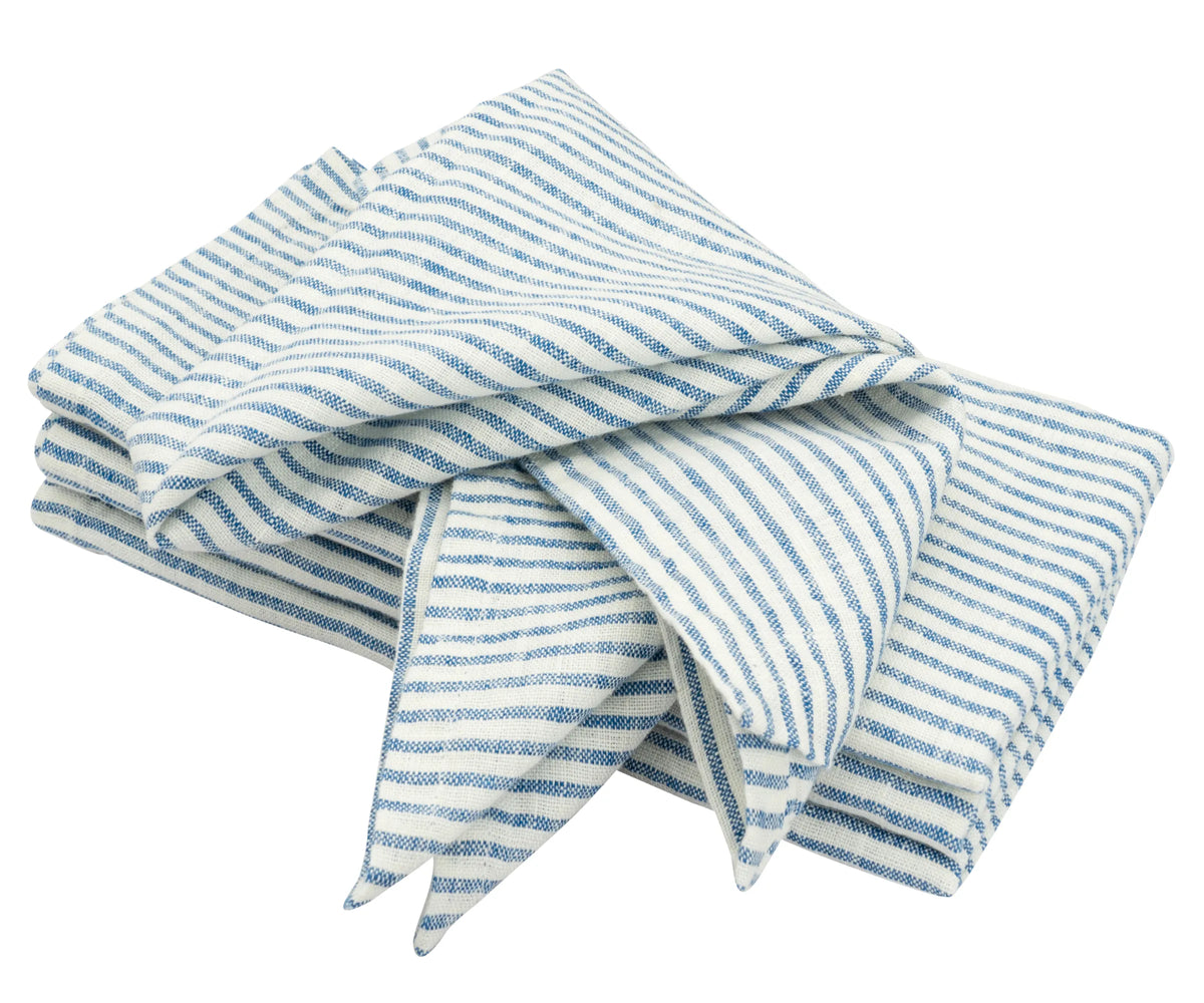 Blue napkin folded on a white plate with cutlery for a casual mealtime setup