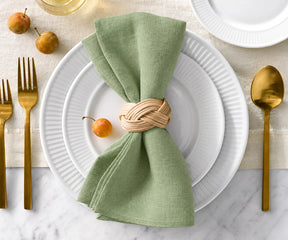 Close-up of sage green linen napkin texture, sage green cloth napkins, linen table accessories for stylish dining décor.