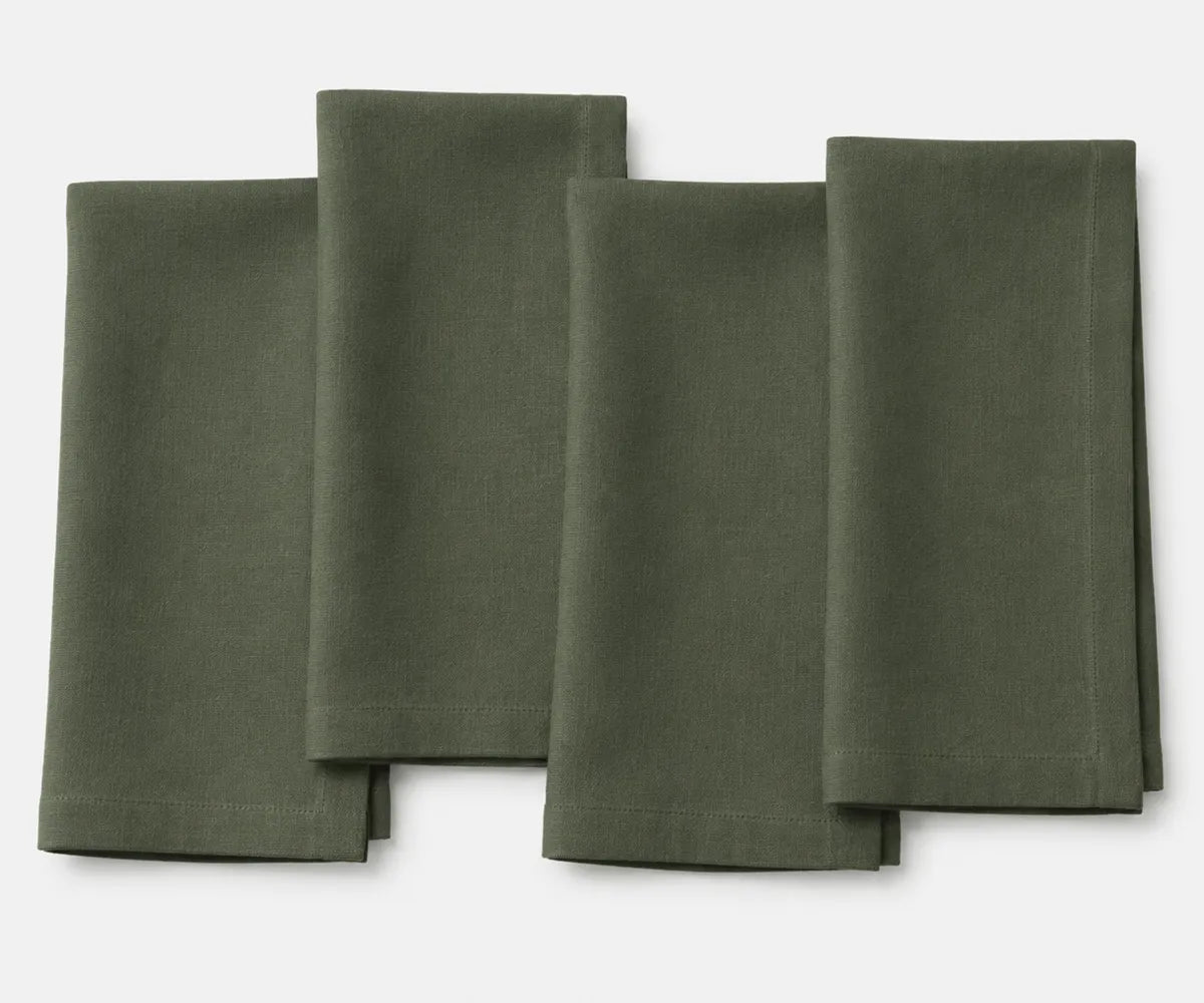 Cypress green plain linen napkin neatly placed, highlighting eco-friendly linen fabric