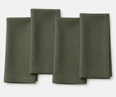 Cypress green plain linen napkin neatly placed, highlighting eco-friendly linen fabric