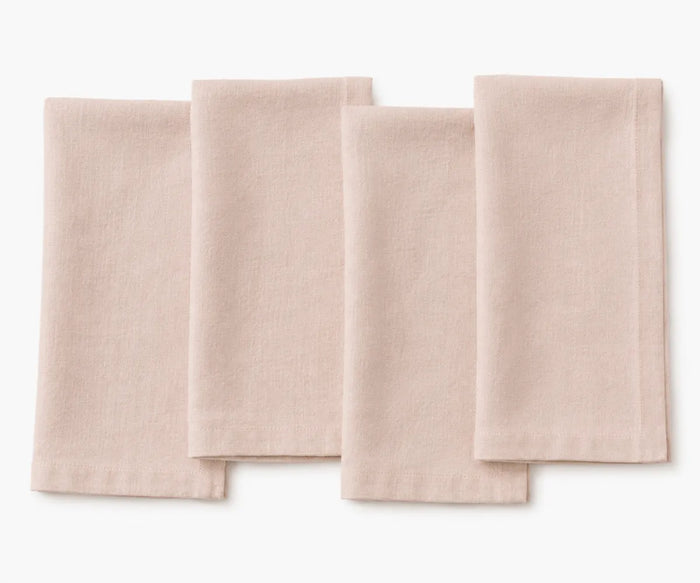 Dusty rose plain linen napkin arranged for table setting, soft romantic fabric texture