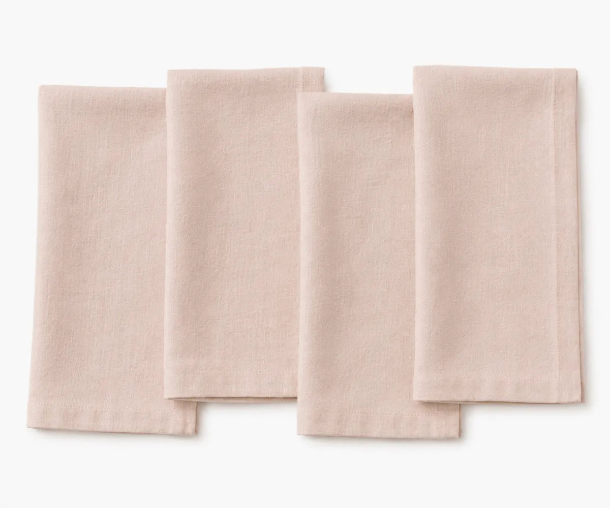 Dusty rose plain linen napkin arranged for table setting, soft romantic fabric texture