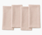 Dusty rose plain linen napkin arranged for table setting, soft romantic fabric texture