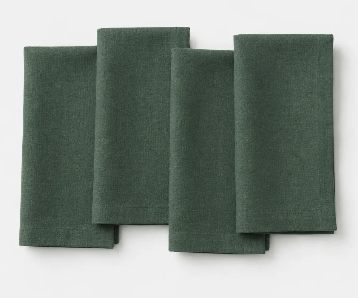 Evergreen linen napkin with deep green shade, neatly folded for dining decor