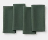 Evergreen linen napkin with deep green shade, neatly folded for dining decor