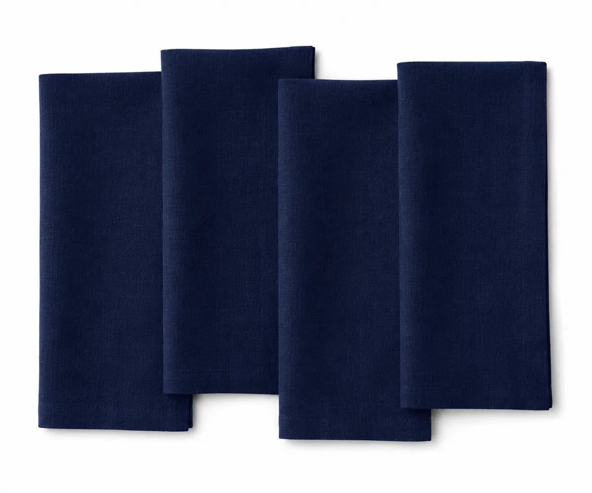 Indigo plain linen napkin neatly stacked, highlighting deep blue shade and fine weave