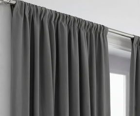 Grey cotton curtains hanging in living room