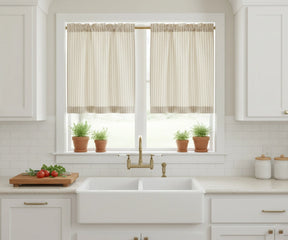 Beige striped half-length curtains providing soft privacy and a modern touch