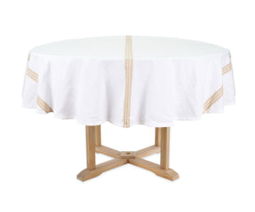 Round table with a white tablecloth featuring gold stripes on a white background