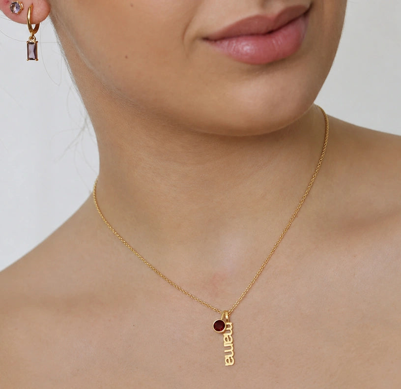 Mama necklace with July ruby birthstone charm in a stylish personalized gold necklace design.
A vibrant ruby birthstone jewelry gift for moms, wives, and special family moments.