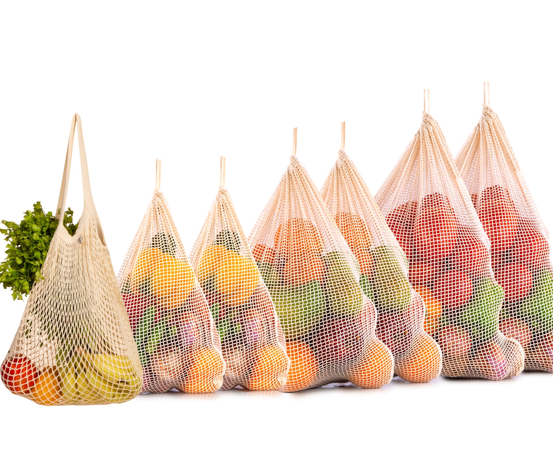 An assortment of five string bags, each filled with fresh produce