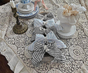 Minimalist black and white pinstripe table linens complementing modern home decor