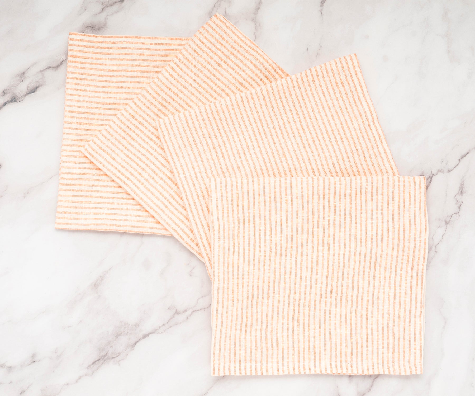 Striped napkins used in a spring-themed table setting with fresh flowers