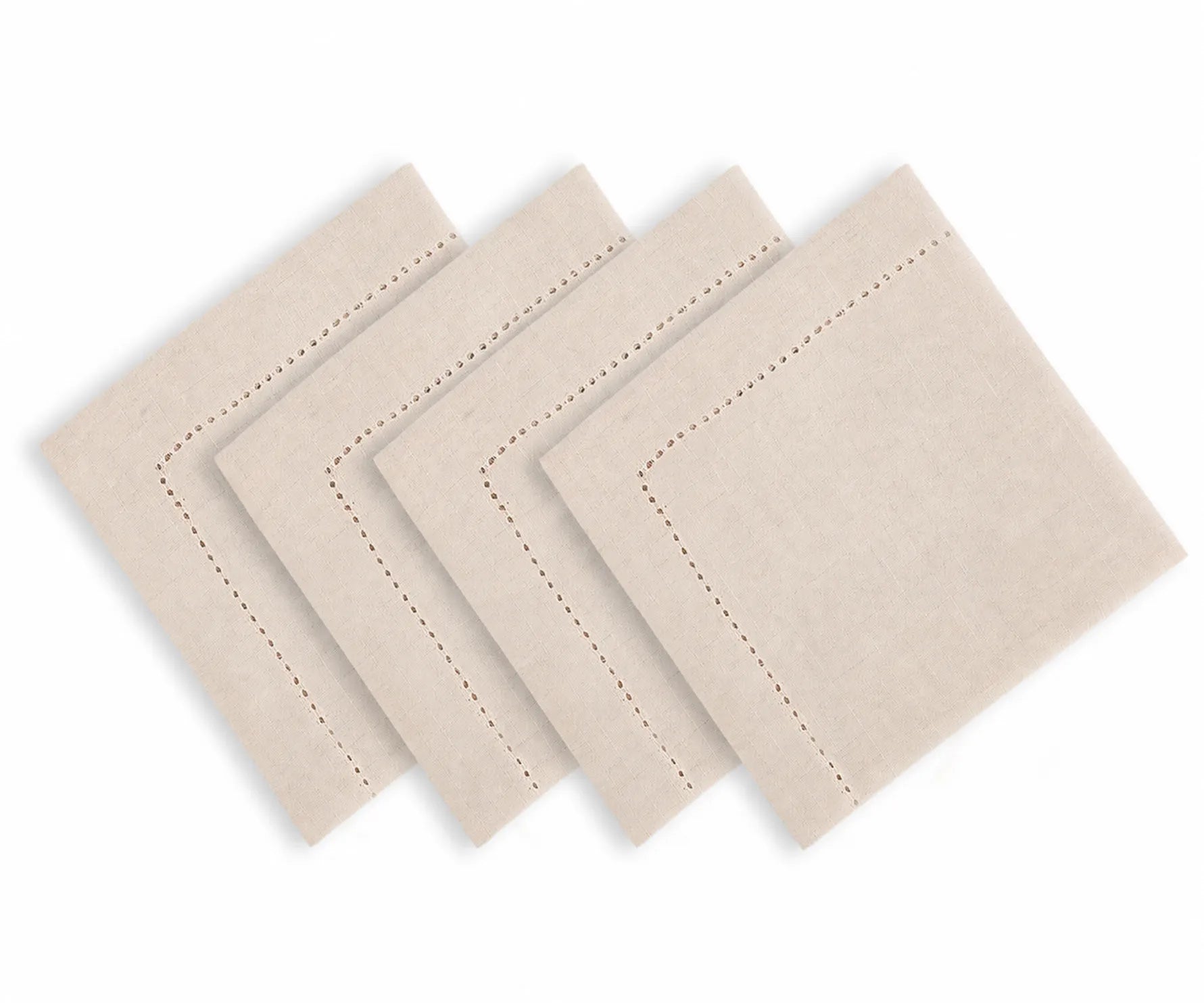 Natural color hemstitched cotton linen blend dinner napkins arranged on an elegant dining table with classic dinnerware and neutral table decor