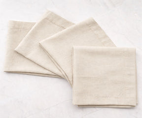 Folded natural cotton linen napkins with clean solid finish, reusable dinner napkins for everyday dining