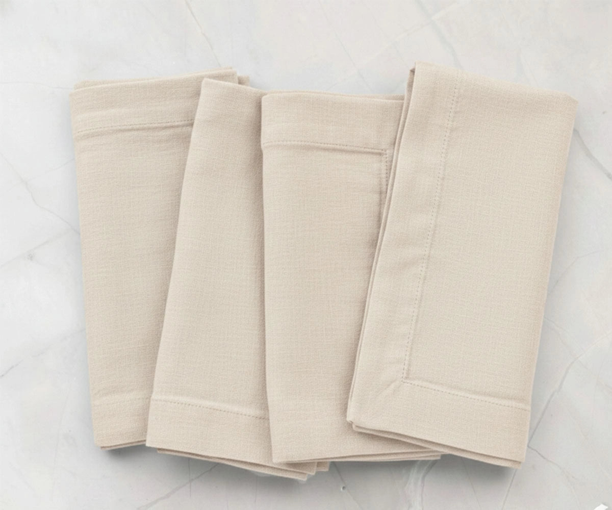 Natural solid cotton linen napkins styled on dining table, reusable fabric napkins