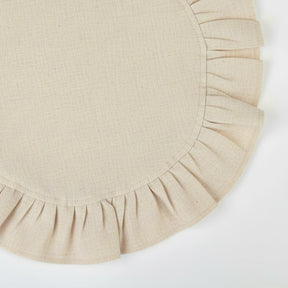 Neutral natural-toned cotton napkins with soft ruffle trim, designed for everyday use and relaxed table settings.