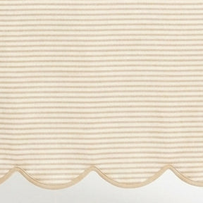 Natural linen striped tablecloth material featuring a detailed scallop hem design for neutral kitchen and dining decor.
