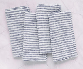 Navy blue cloth napkins by All Cotton and Linen arranged on a sophisticated dining table for everyday meals and celebrations.