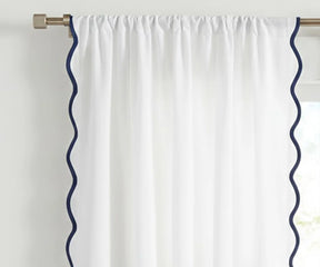 White scalloped curtain panel with navy blue trim