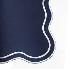 Reusable navy blue cotton scalloped napkins with white embroidered trim for dinner parties, restaurants, Christmas tables, and luxury dining room settings.