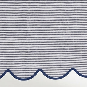 Close-up of navy blue and white thin striped linen tablecloth fabric highlighting the decorative navy scalloped edge border.