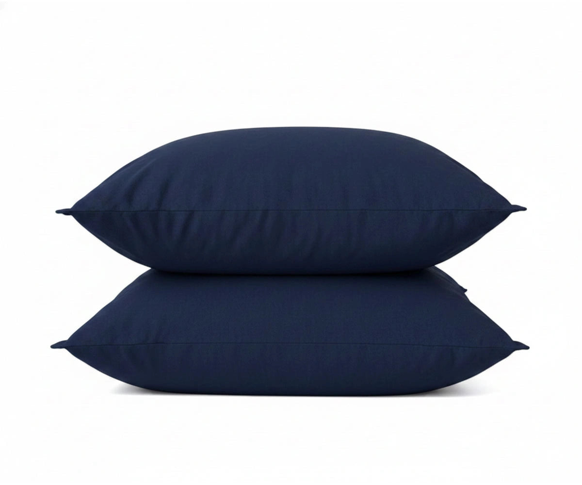Navy blue linen pillowcases stacked on top of each other, showcasing soft fabric detail.