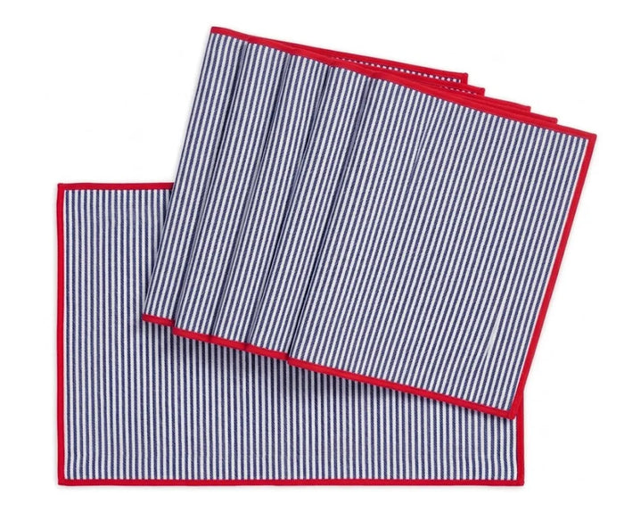 Navy blue and white striped cotton placemats with red edge trim on farmhouse dining table, washable rectangle table mats set