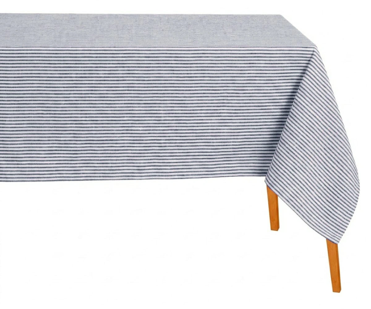 Rectangular navy blue and white horizontal striped cotton tablecloth draped over a wooden table against a white background.