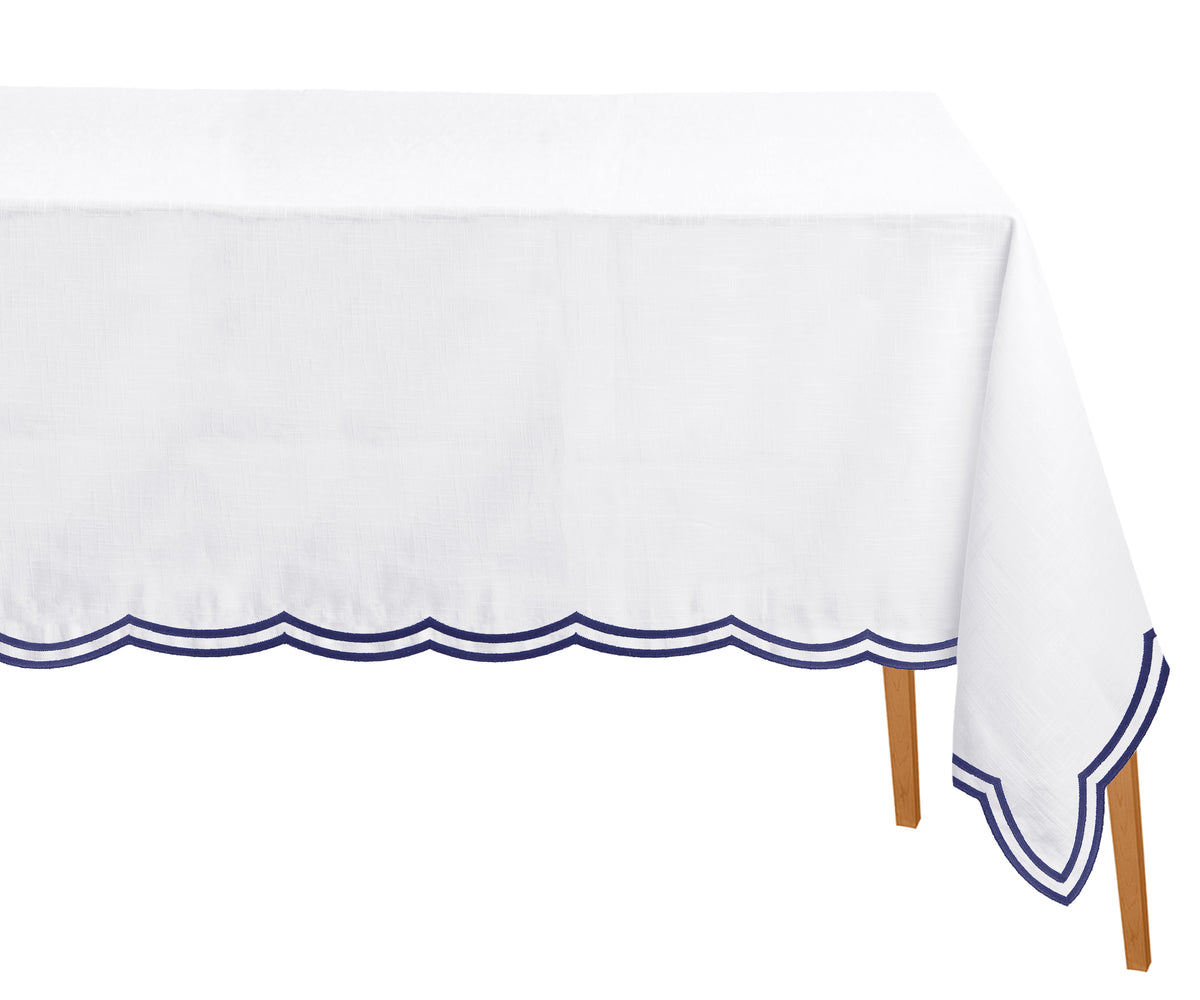 Elegant navy blue rectangular tablecloth with scalloped edges and subtle embroidery, styled for a classic dining setup