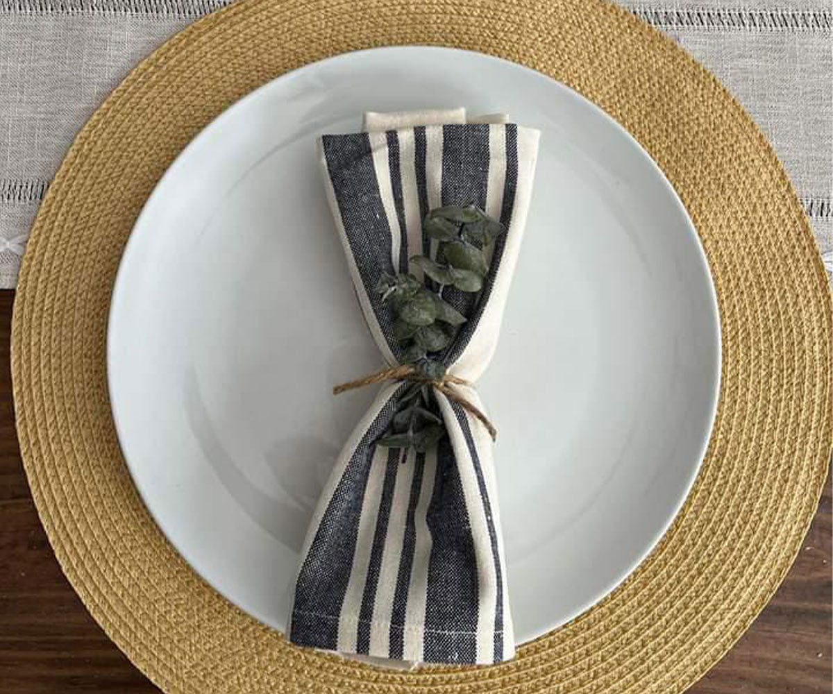 Fresh blue stripe napkins enhancing a spring-themed table arrangement.