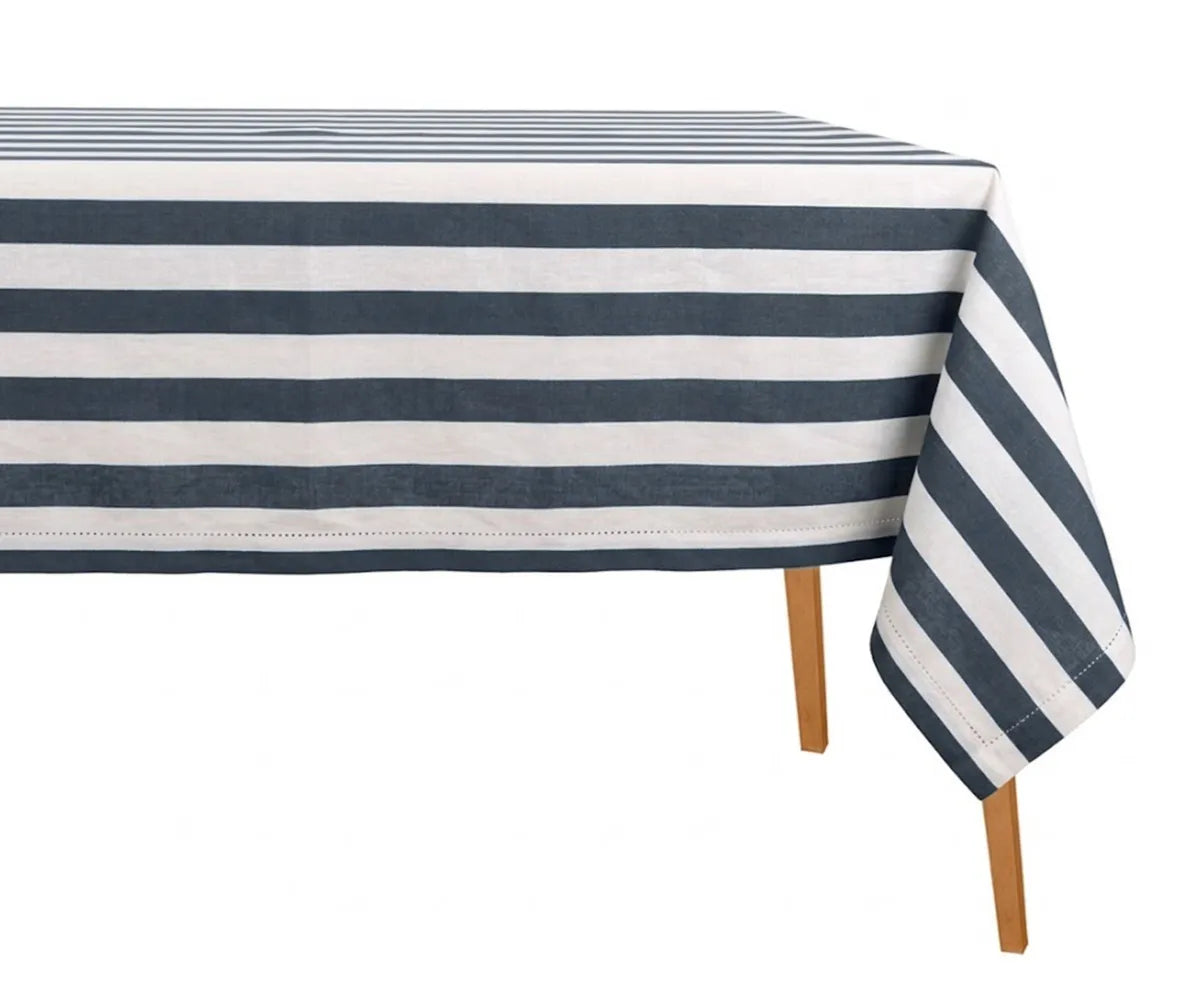 Hemstitched cabana stripe table linen covering a rectangle dining table in a coastal interior