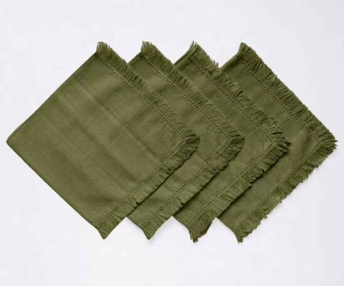 Cotton cloth napkin set with fringed borders, sustainable alternative to disposable napkins for eco-friendly dining.