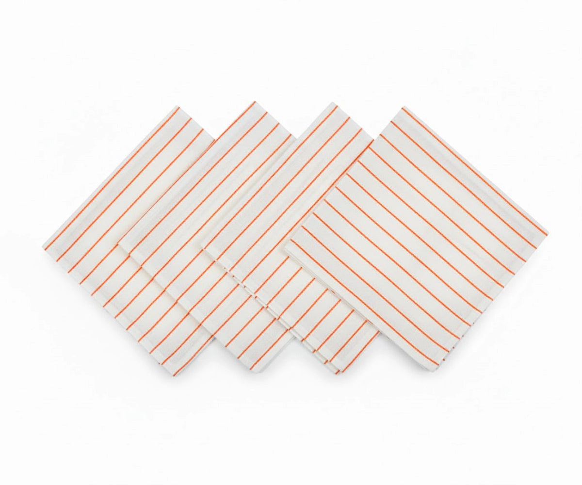 Set of orange striped cotton napkins laid flat