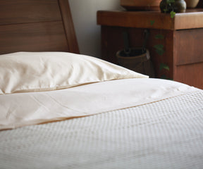 Bed featuring a white cotton fitted sheet