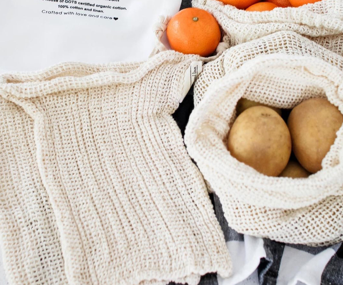 Oranges and potatoes packed in an eco-friendly mesh produce bag