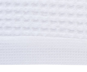 Close-up image displaying the organic cotton waffle weave texture that promotes quick drying and durability.