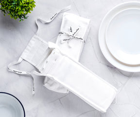 White plate and bistro napkin setup with cutlery