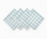 Set of light blue and white checked cotton napkins laid flat